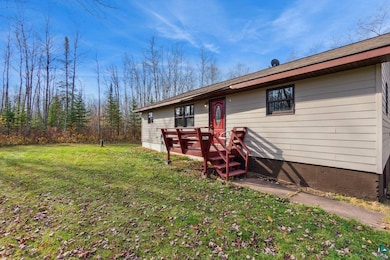 Back of house featuring a deck and a yard