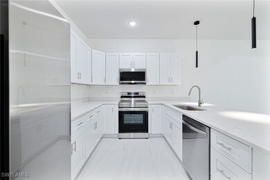 Kitchen featuring white cabinetry, marble finish f