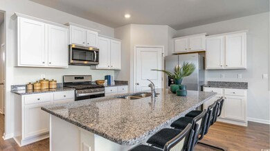 Kitchen with dark wood-type flooring, white cabine