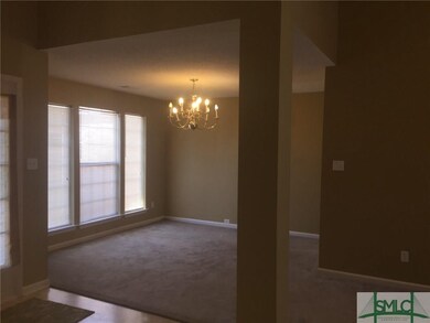 Separate Dining Room with Beautiful Light Fixture 