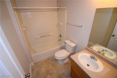 Full bathroom featuring shower / tub combination, vanity, and light tile patterned floors
