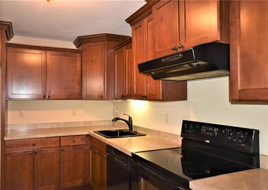 Kitchen has custom cherry wood cabinets.