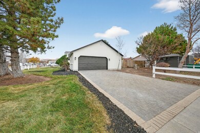 View of front of house with a garage, decorative driveway, and stucco siding
