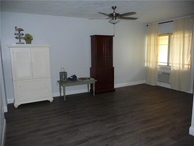 Living room has wood laminate flooring;larger base