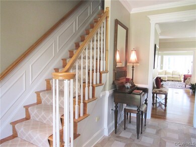 Foyer has beautiful trim & stone floor. Front and