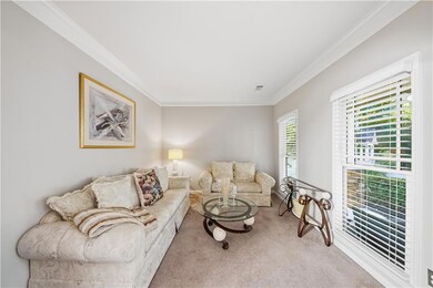 Living room with crown molding and carpet flooring