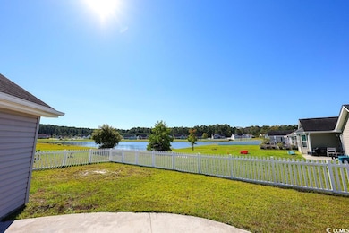 Fenced backyard featuring a water view