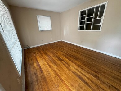 Empty room featuring wood-type flooring