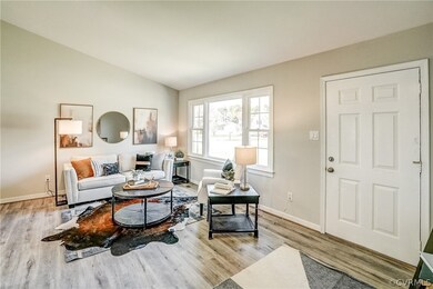 Living room with light hardwood / wood-style floor