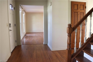 Corridor with dark hardwood / wood-style flooring