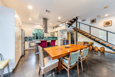 Dining area featuring stairs, finished concrete f