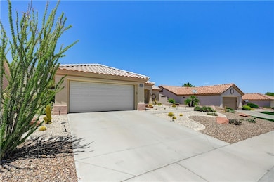 View of front of property with stucco siding, a ti