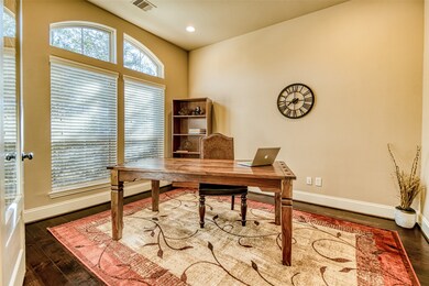Directly to the left of front door is an office with hardwood flooring.