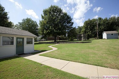 Additional view of huge backyard and storage shed.