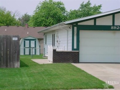 Deep roof overhangs front and sides of the home. N