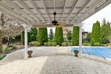 Enjoy this patio year round under the custom pergola and fan. 