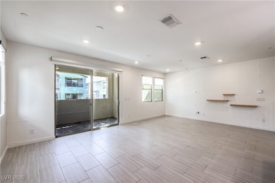 Empty room with recessed lighting and light wood-t
