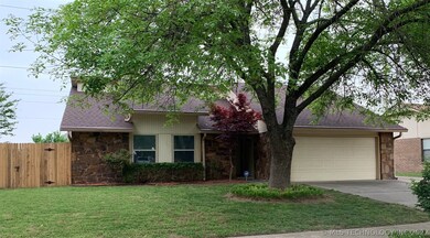Front view. Over sized driveway to the right.