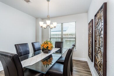 As you continue down the entry, you will find this wonderful formal dining room. The wall of windows allows plenty of natural sunlight. Room for those family gatherings.