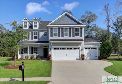 3 car garage with triple parking pad and covered g