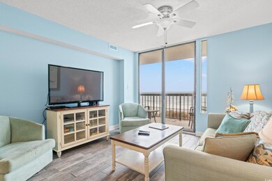 Living room with expansive windows, ceiling fan, h