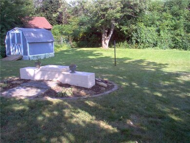 Land. Another view of rear yard.That is a planter 