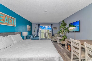 Bedroom featuring an AC wall unit, access to outsi
