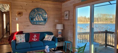 Living room portion with slider to deck