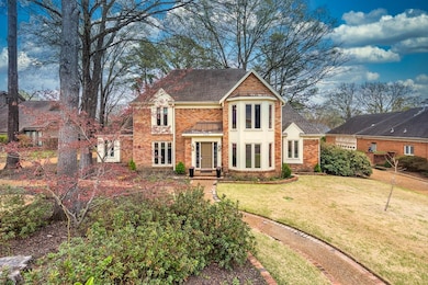 View of front of property with brick siding, a fro