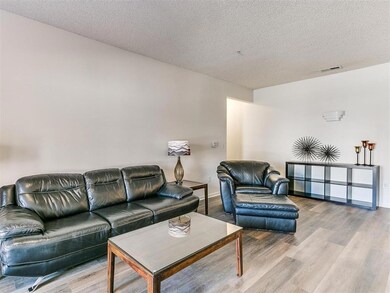 Living area featuring a textured ceiling, wood fin