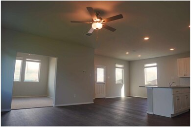 Kitchen featuring open floor plan, dark wood fini