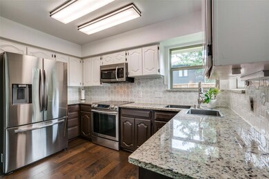 Open-concept kitchen with beautiful granite counte