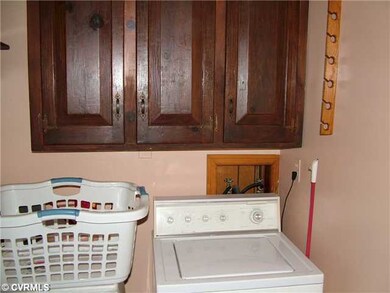 Laundry - utility room on rear of home has cabinet