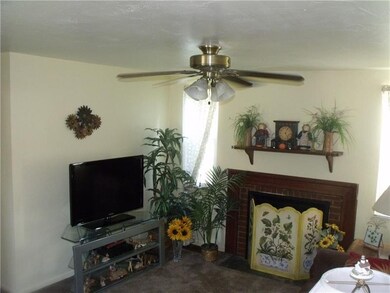 Living room with cozy log burning fireplace