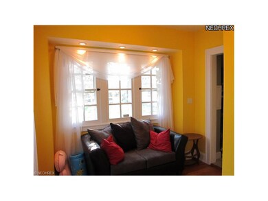 Sun room looking from living room. Back door foyer and half bath to the right