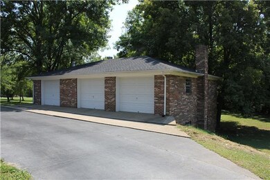 A man's dream shop!!! 3 Car Garage on Top, 4 Car Garage under; Has water, electric, & natural gas run to it.