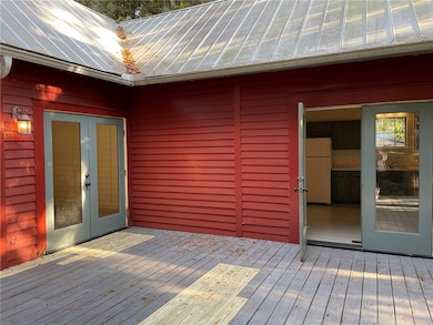 Kitchen on right, primary bedroom on left