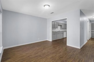 Spare room featuring dark hardwood / wood-style fl