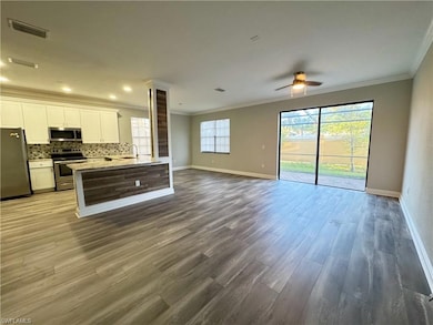 Kitchen with stainless steel appliances, open floo