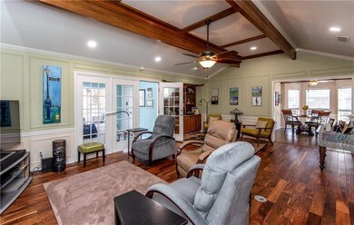 View from entry into den, open to the kitchen and 