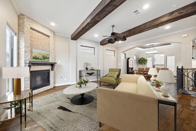 Family room showcasing exposed wood beams, a mosai