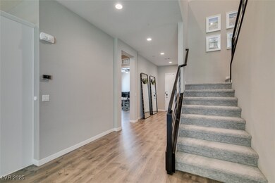 Staircase with recessed lighting and wood finished floors