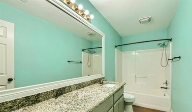 Full bathroom with shower / bathing tub combination, wood-type flooring, toilet, and large vanity