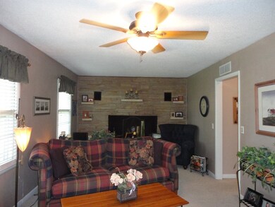 Living room has carpet, hardwood floors underneath