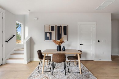 Dining space featuring stairs and light wood-style flooring