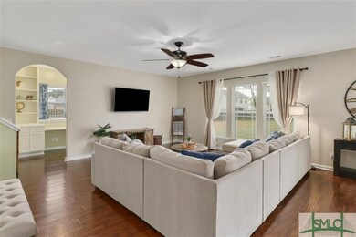 Living room with office entrance which has a full 