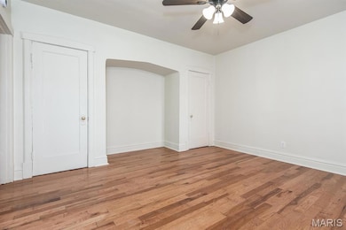 Unfurnished bedroom featuring wood finished floors and a ceiling fan