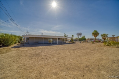 Rear view of house featuring fence and a patio