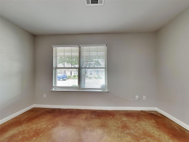 Empty room featuring baseboards