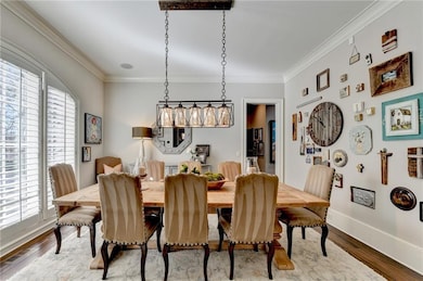 Dining space featuring wood finished floors, a hea